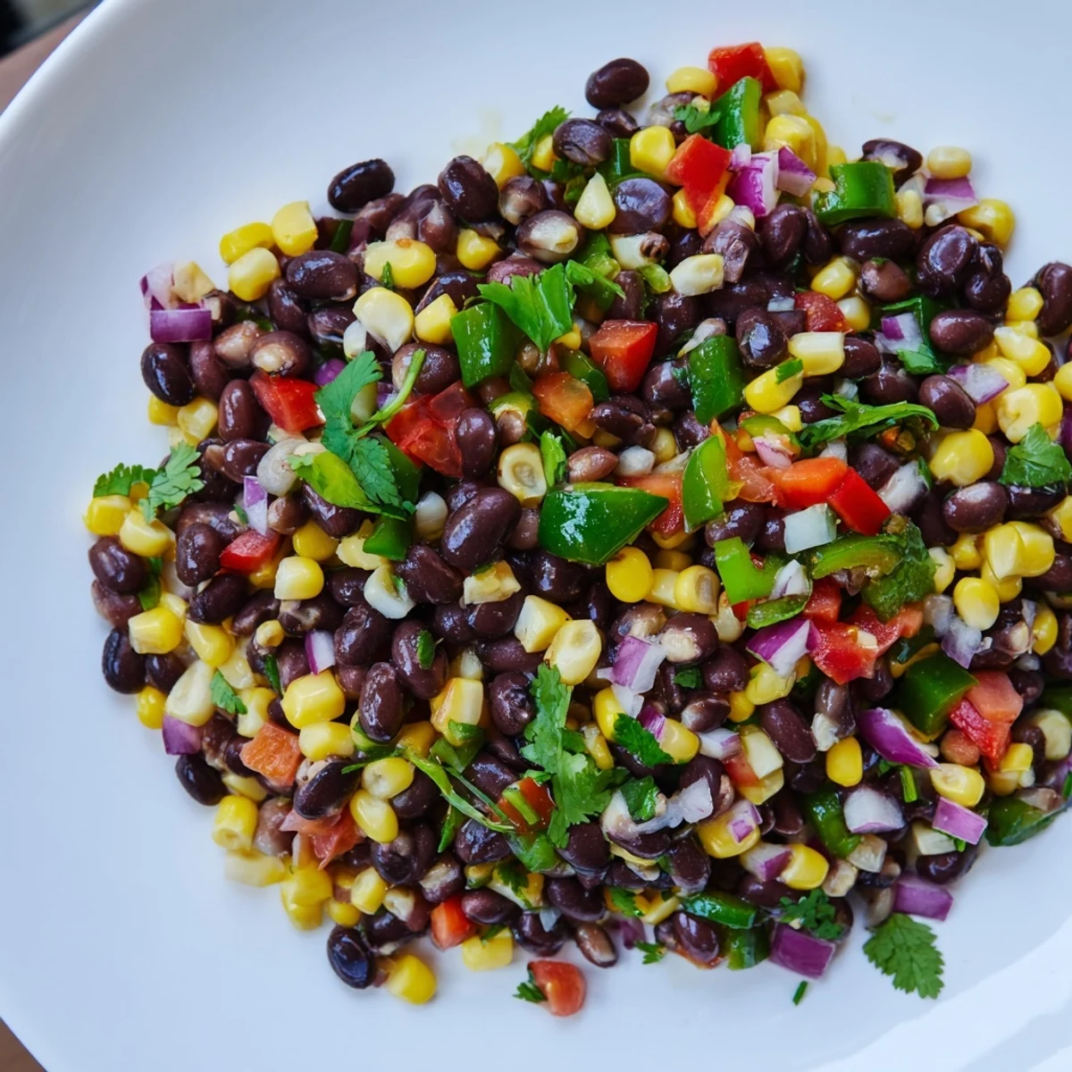 Close up shot of fresh Cowboy Caviar Salad, showcasing the bright colors and textures.