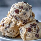 Lush Greek Yogurt Cookie Dough in a white bowl is garnished with extra chocolate chips and perfect for a quick dessert.