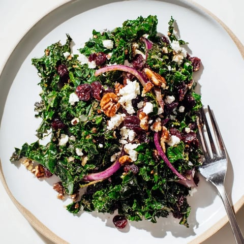 Bright, massaged kale glistens with warm maple mustard dressing, dotted with toasted pecans and sweet dried cranberries.  