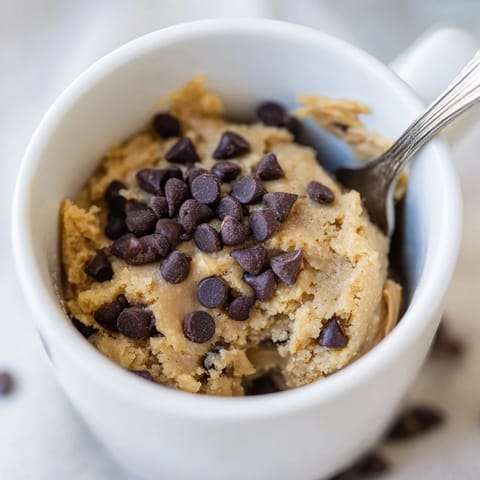 A single serving of a perfectly cooked 2-Minute Peanut Butter Mug Cake, sprinkled with chocolate chips.