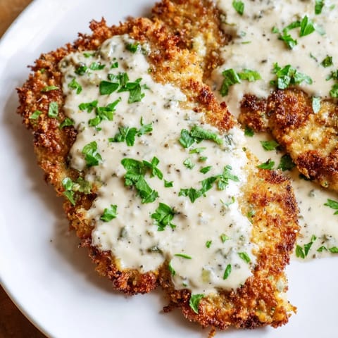 Imagine savory, crispy chicken with garlic cream sauce, a satisfying and easy weeknight meal at home.