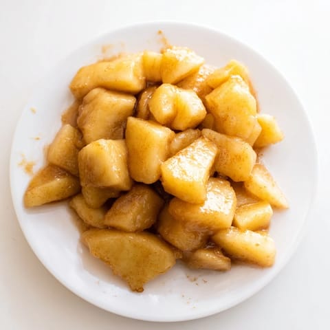 Picture tender slow cooker stewed apples, a glossy topping ready for pancakes on a sunny morning.
