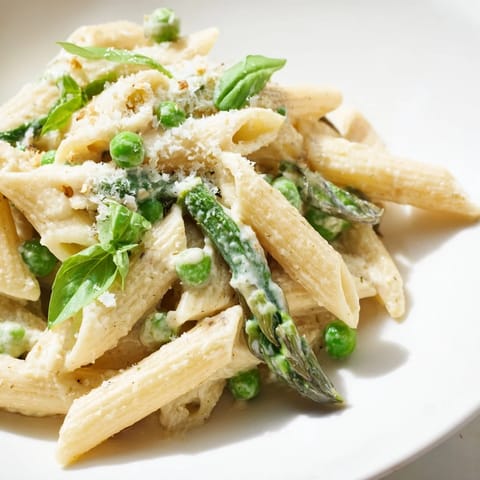 Garlic Parmesan Spring Vegetable Pasta served steaming hot, topped with extra grated Parmesan and a bright lemon zest.