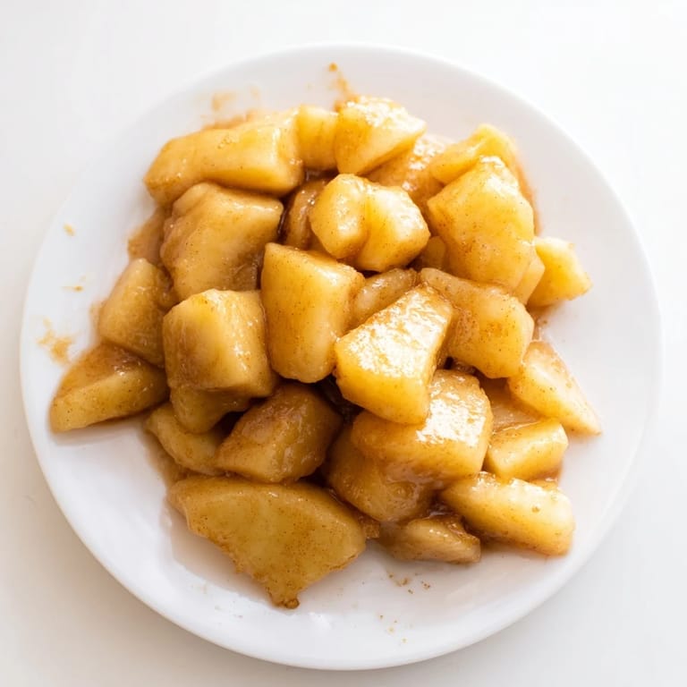 Picture tender slow cooker stewed apples, a glossy topping ready for pancakes on a sunny morning.