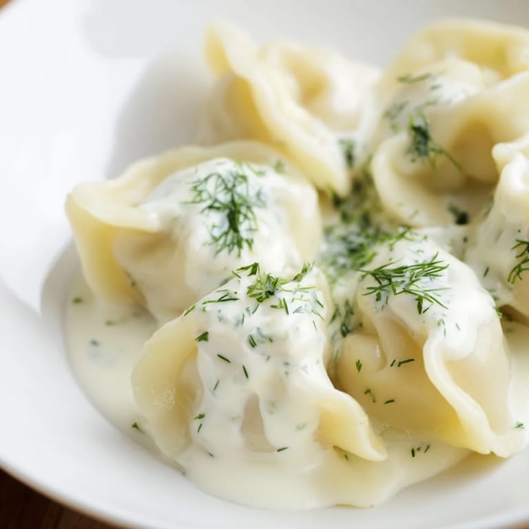 A close-up of fluffy Russian pelmeni, showcasing their perfectly crimped edges and delicious fillings.